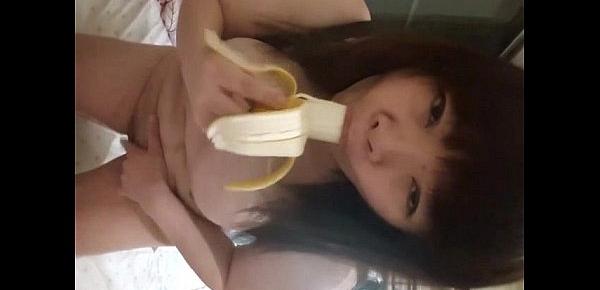  Asian playing with a banana before jamming it in her pussy